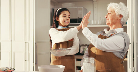 Happy grandma, grandchild or baking with high five in kitchen for success or dessert recipe in...