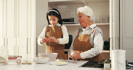 Baking, egg and child with grandmother in kitchen for teaching, bonding or development. Happy, learning and girl kid with senior woman for preparing dessert, cake or cookies together in home.