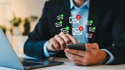 Person using smartphone with multiple email icons and status indicators message communication