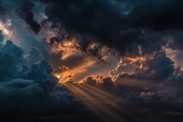 Obraz premium Dramatic cloudscapes with sunbeams piercing through dark storm clouds