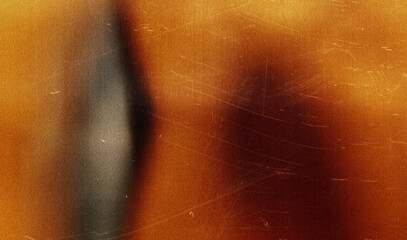 grainy colorful warm orange light leaks on black background with dust texture.