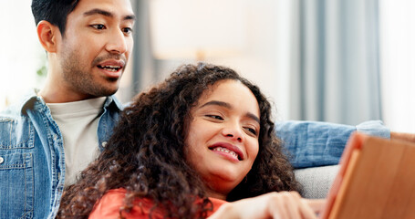 Couple, relax and smile with tablet on sofa for website browsing, online shopping or app sign up....