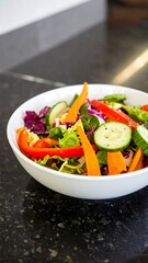Colorful salad in a white bowl on a dark countertop
