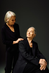 Elegant mature lesbian couple celebrating love and romance in fashionable attire