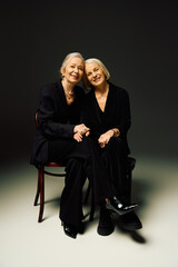 Mature couple joyfully embraces love while showcasing their elegant fashion sense together