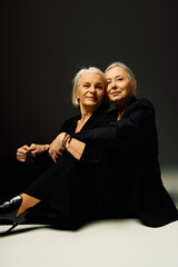 Mature lesbian couple expressing love and elegance through their stylish attire