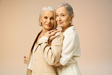 Elegant mature lesbian couple showcasing timeless fashion and romance in a warm embrace
