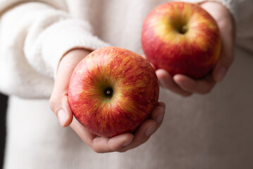 Red apple fruit (Envy apple) holding by woman hand, Healthy eating