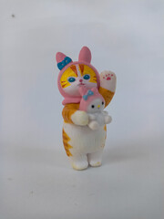 Cute collectible cat figurine with whimsical design, symbol of playfulness, innocence, and kawaii...