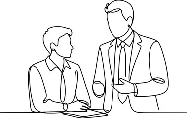 Two business people engaged in conversation at a desk one standing the other sitting