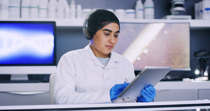 Woman, scientist and check tablet in lab for medical research, microbiology study and hairnet for hygiene. Science, ppe for safety and female doctor with digital results for healthcare innovation