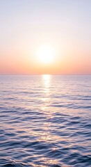 Obraz premium Serene Ocean Sunset with Golden Sun Reflection on Gentle Waves water