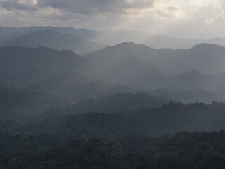 Sunset in the mountains with clouds and sunbeams, Thailand