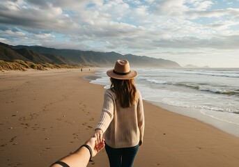 A romantic travel photo from the perspective of a person following their partner on a scenic beach
