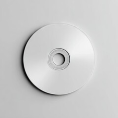 A blank, silver-white disc sits centered on a light gray background, showcasing its smooth, reflective surface and concentric rings