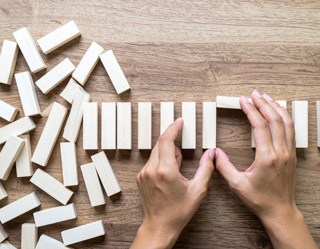 Hands building an orderly bridge from chaotic blocks. A concept for problem-solving, strategy, and solutions