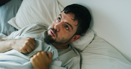 Insomnia, man and anxiety from drug addiction in bed with withdrawal symptoms, restless or craving....
