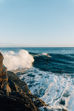 Adult male surfing waves at China Wall in Honolulu, Hawaii