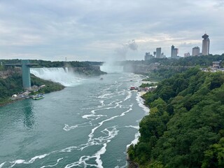 View of Niagara Falls with two tourist boats navigating the river