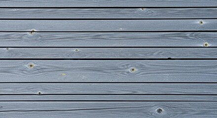 Weathered and painted grey wood paneling with horizontal slats and natural knots for texture
