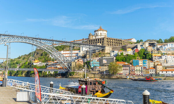 View of Porto cityscape along the Douro river with Luis I bridge in foreground, Porto, Portugal.