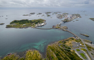 Drone aerial scenic view of a henningsvaer coastal village surrounded by islands and serene waters in Lofoten Norway