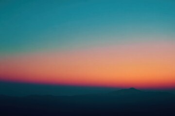 Obraz premium Sunset over a mountain range. Soft, vibrant colors