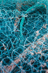 Gallipoli fishing net close up blue texture detail with blurred sea background