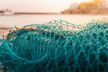 Gallipoli harbor fishing nets turquoise color with sea and boats in background