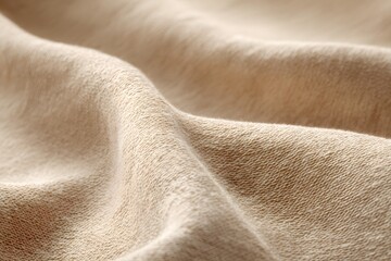 Photo of a close-up view of the texture and color of beige fabric, focusing on its softness and subtle gradient