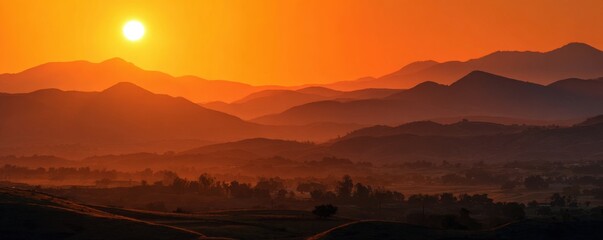 Sunrise over a hazy mountain range