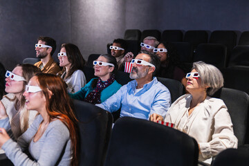 Multi ethnic group enjoying a 3d film at the movie theater, experiencing immersive entertainment