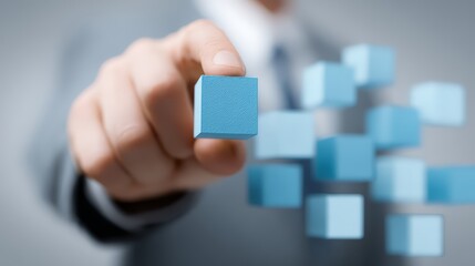 A businessman holding a cube often symbolize data blocks, digital packages, or abstract computational elements (like a cloud service or blockchain).
