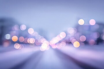 An out-of-focus image of a road at dusk, with indistinct buildings and glowing street lights creating a dreamy, blurry, bokeh-filled visual