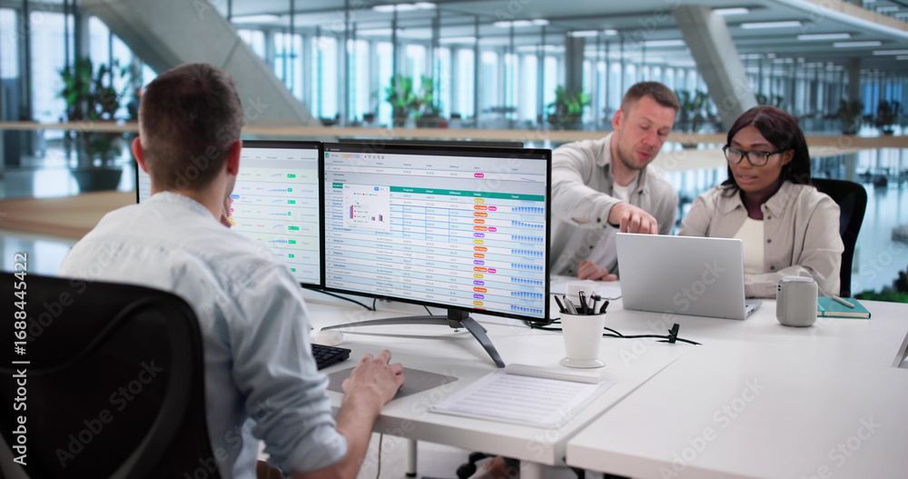 Poster analyzing billing reports with spreadsheet software: diverse business team