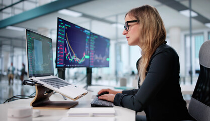 Trader Analyzing Stocks With Multiple Screens In A Financial Company Office