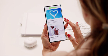 Charitable Young Woman Using Smartphone