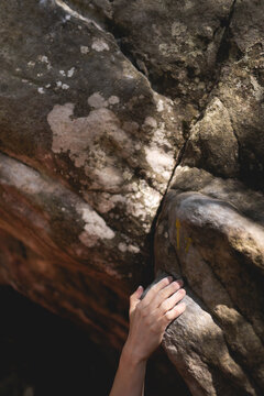 The hand of a boulder climber on yellow route 4