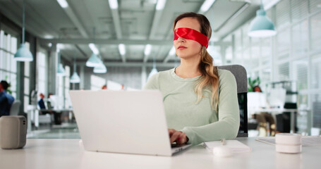 Blindfolded Man Struggles With Computer At Office Desk