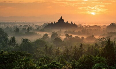 Sunrise over ancient temple shrouded in mist