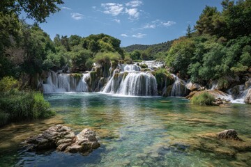 Obraz premium Scenic waterfall cascade in lush green valley