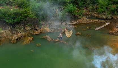 Obraz premium Fishermen catch fish with nets on Quay Son River, Cao Bang. Photo taken on August 29, 2025