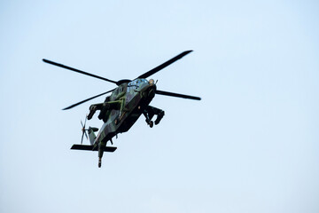 Helicopter is flying over isolated blue sky 