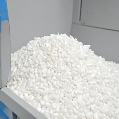 Pile of white packing peanuts in a storage bin