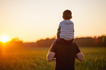 Father and Son Enjoying Sunset on His Shoulders