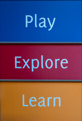 Colorful Play Explore Learn poster with white text