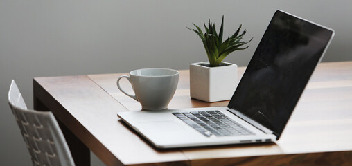 Office setup with a laptop on table along with peaceful environment- perfect for work- WFH- work from home