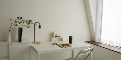 white table beside window with a chair study lamp note book - study room