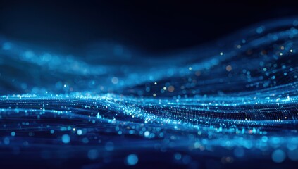 Abstract digital wave of glowing particles.  Deep blue background.  Soft, blurred, glowing particles form undulating waves