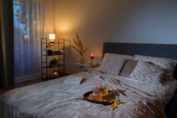cup of tea on cozy bed with autumn decorations